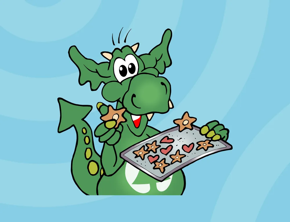 Der kleine grüne Drache INGO mit einem Blech frisch gebackener Kekse in den Händen