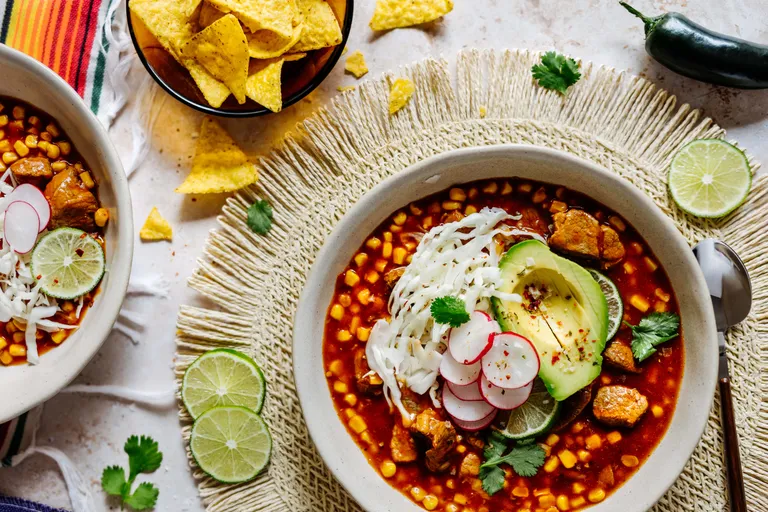 Traditionelle mexikanische Pozole mit Avocado, Kohl, Radieschen und Limette