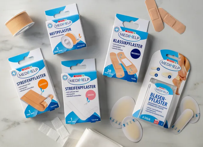 Eine Vielzahl an unterschiedlichen Arten von Pflastern, wie Heftpflaster oder Streifenpflaster, der Eigenmarke von SPAR "MediHelp".