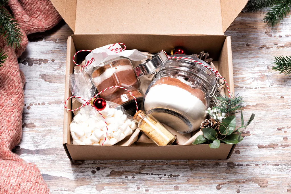 Eine Kartonbox mit Geschenken, die in Marmeladegläsern verpackt wurden