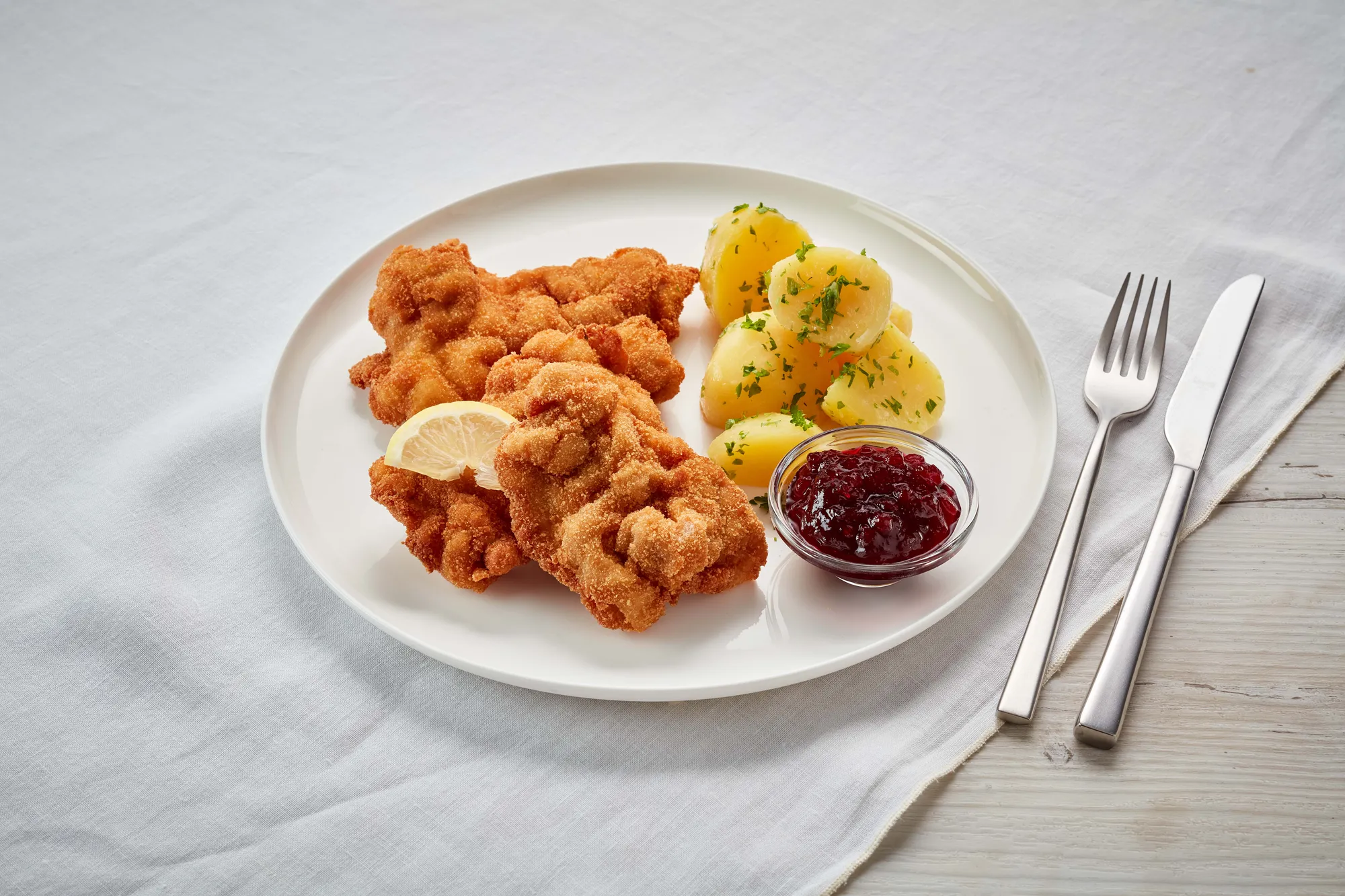 Backhendl (ausgelöste Hühnerkeulen) mit Petersilienkartoffeln und Preiselbeeren aus dem INTERSPAR-Restaurant