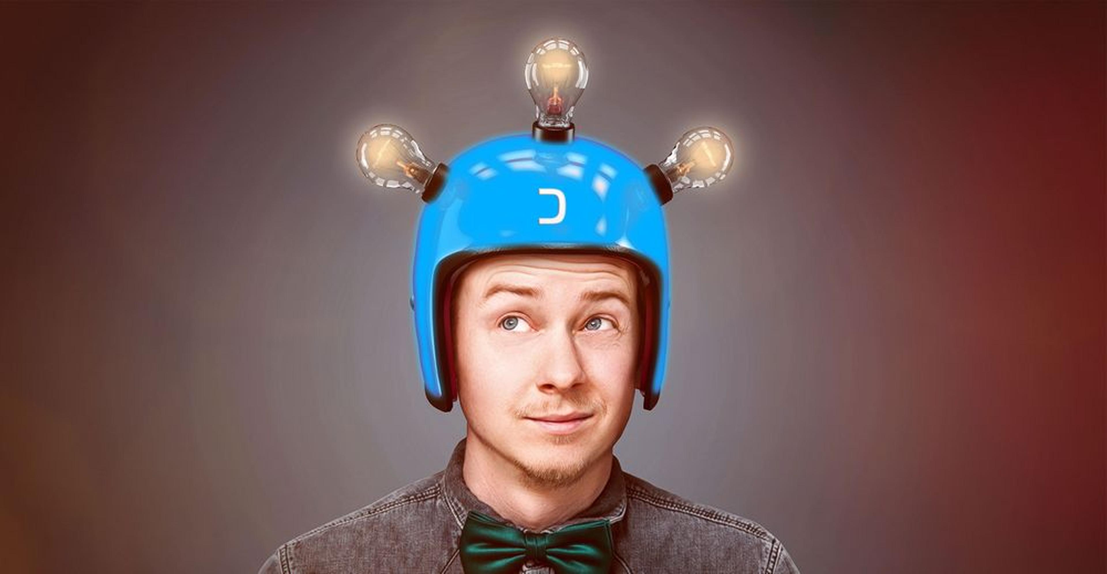 Man wearing a blue helmet with three lit bulbs on top, looking upwards, wearing a bow tie and gray shirt.