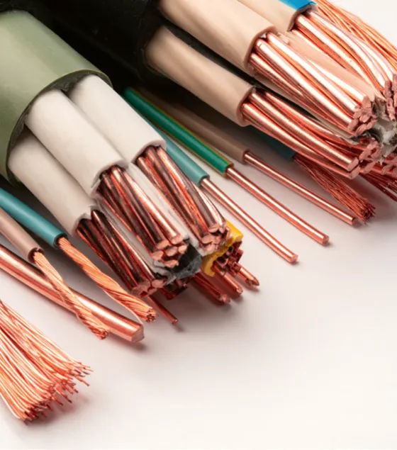 Close-up of various exposed copper wires with different insulation colors, showcasing twisted and stranded wire ends on a white surface.