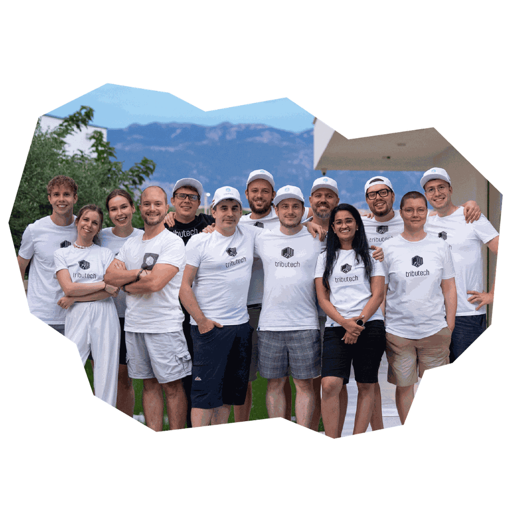 A group of people wearing matching shirts and hats, standing outdoors with mountains in the background.