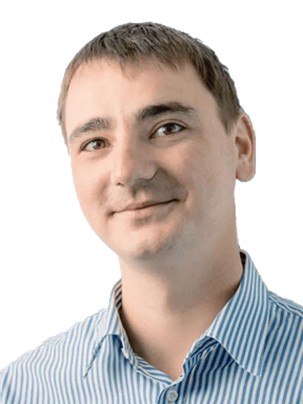 Smiling man with short hair in a blue-striped shirt, looking slightly to the side, on a transparent background.