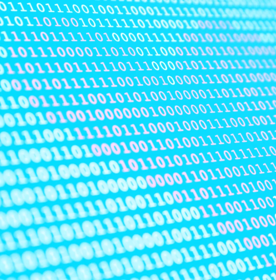 Close-up of binary code in white and pink on a blue background, representing digital data or computing.