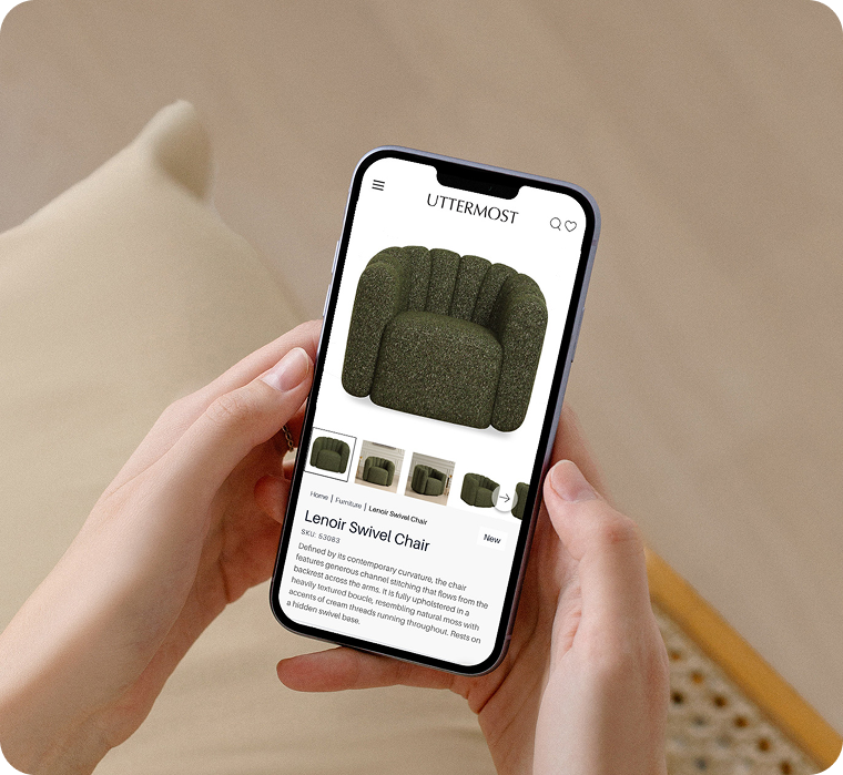 Hands holding a phone showing the Uttermost product page for the Lenoir Swivel Chair