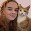 A ginger woman next to a ginger cat