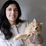 Woman holding a fluffy ginger cat