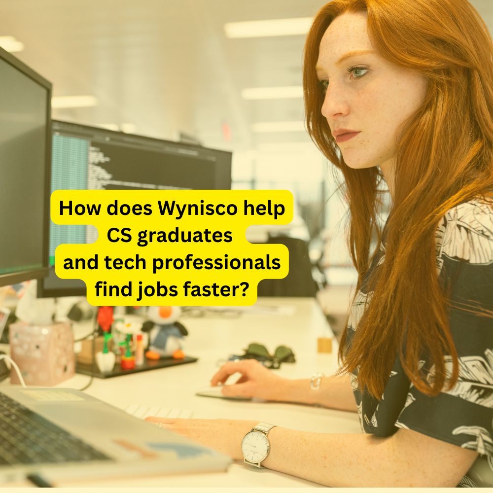 A woman with red hair works on a computer in an office, with text about Wynisco helping CS graduates and tech professionals find jobs faster.