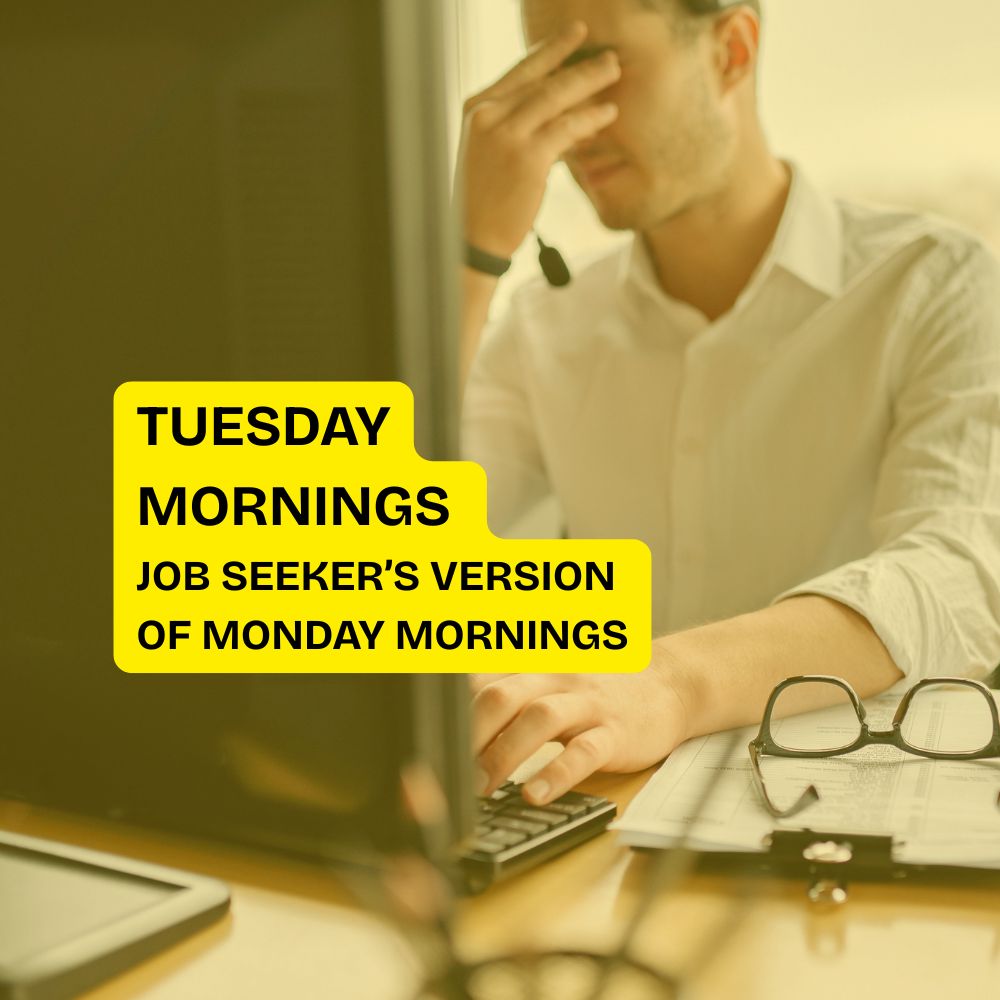 Person in office attire, sitting at a desk with a computer, appears stressed. Text overlay reads: "Tuesday Mornings, Job Seeker's Version of Monday Mornings."