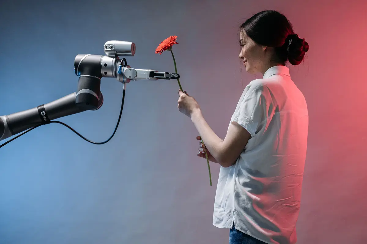 Ai models - a person giving a flower to a robotic arm