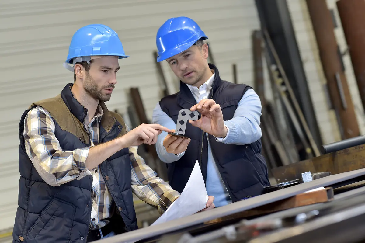 2 men inspecting a part