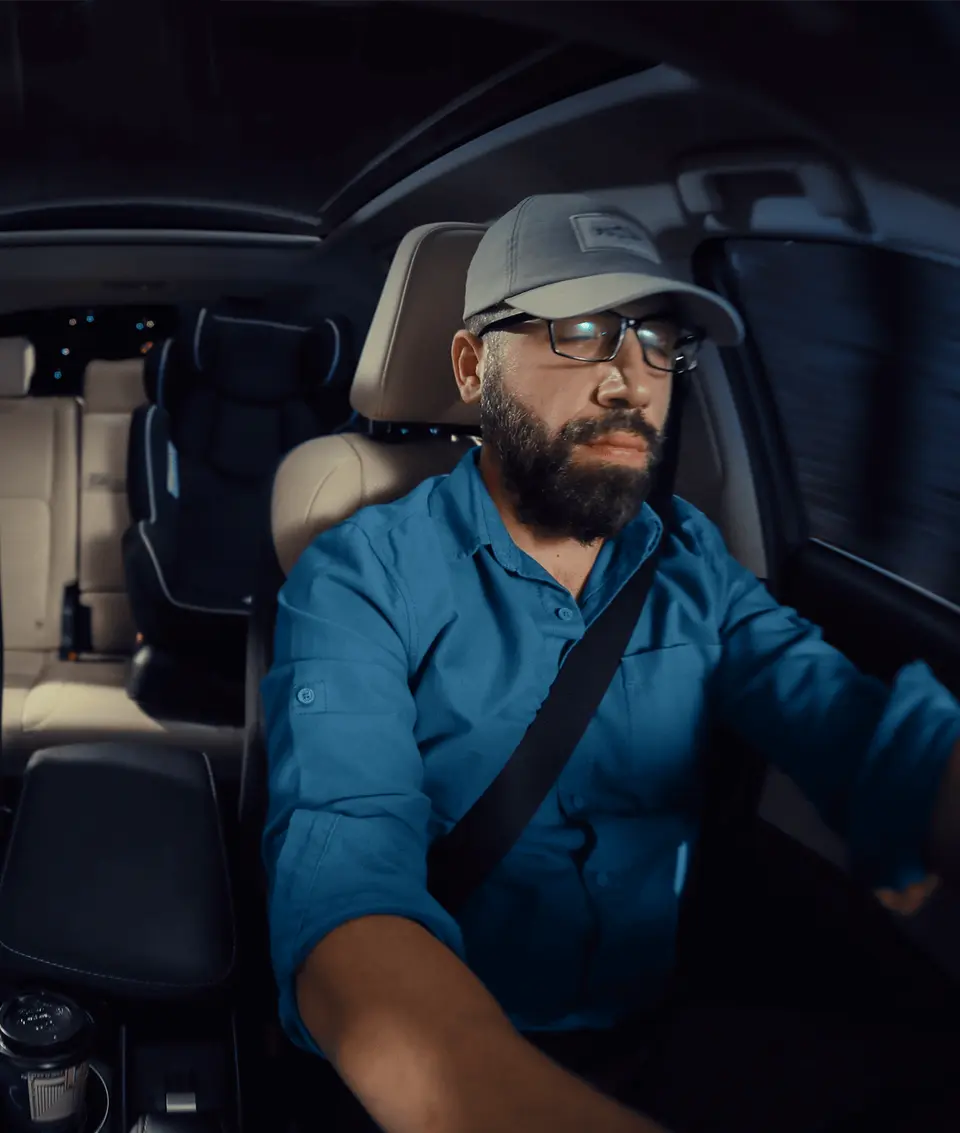 A sleepy driver behind the wheel of a car