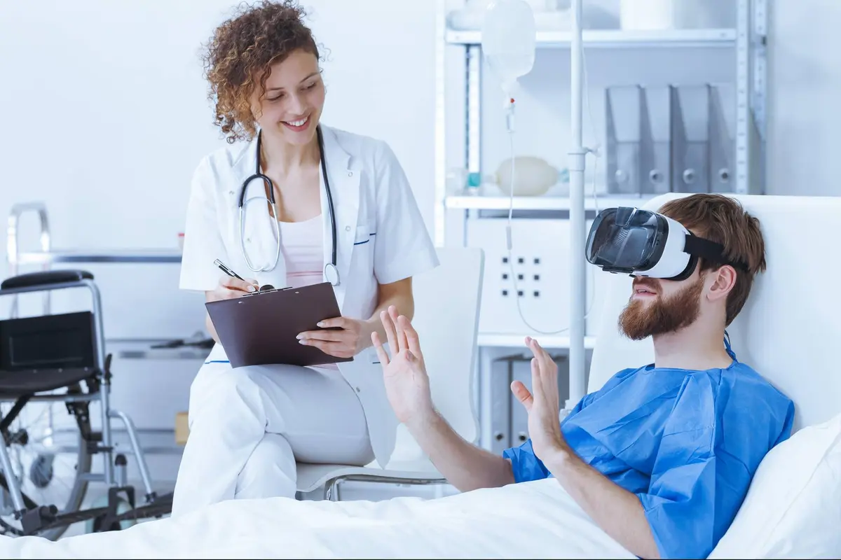Man wearing a VR headset in a hospital bed 