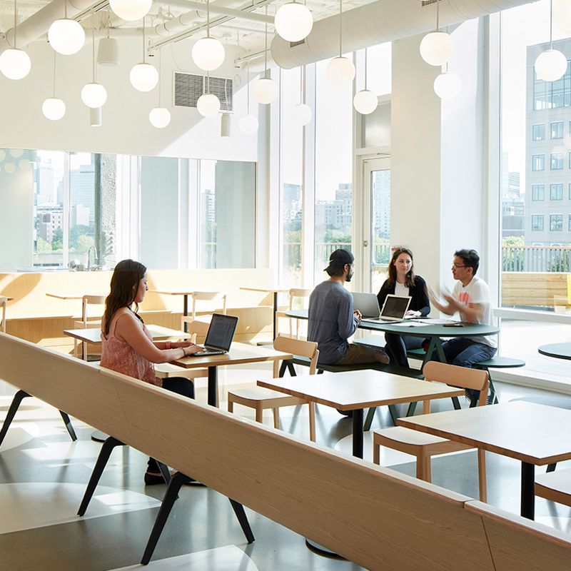 Modern office space with people working and chatting.