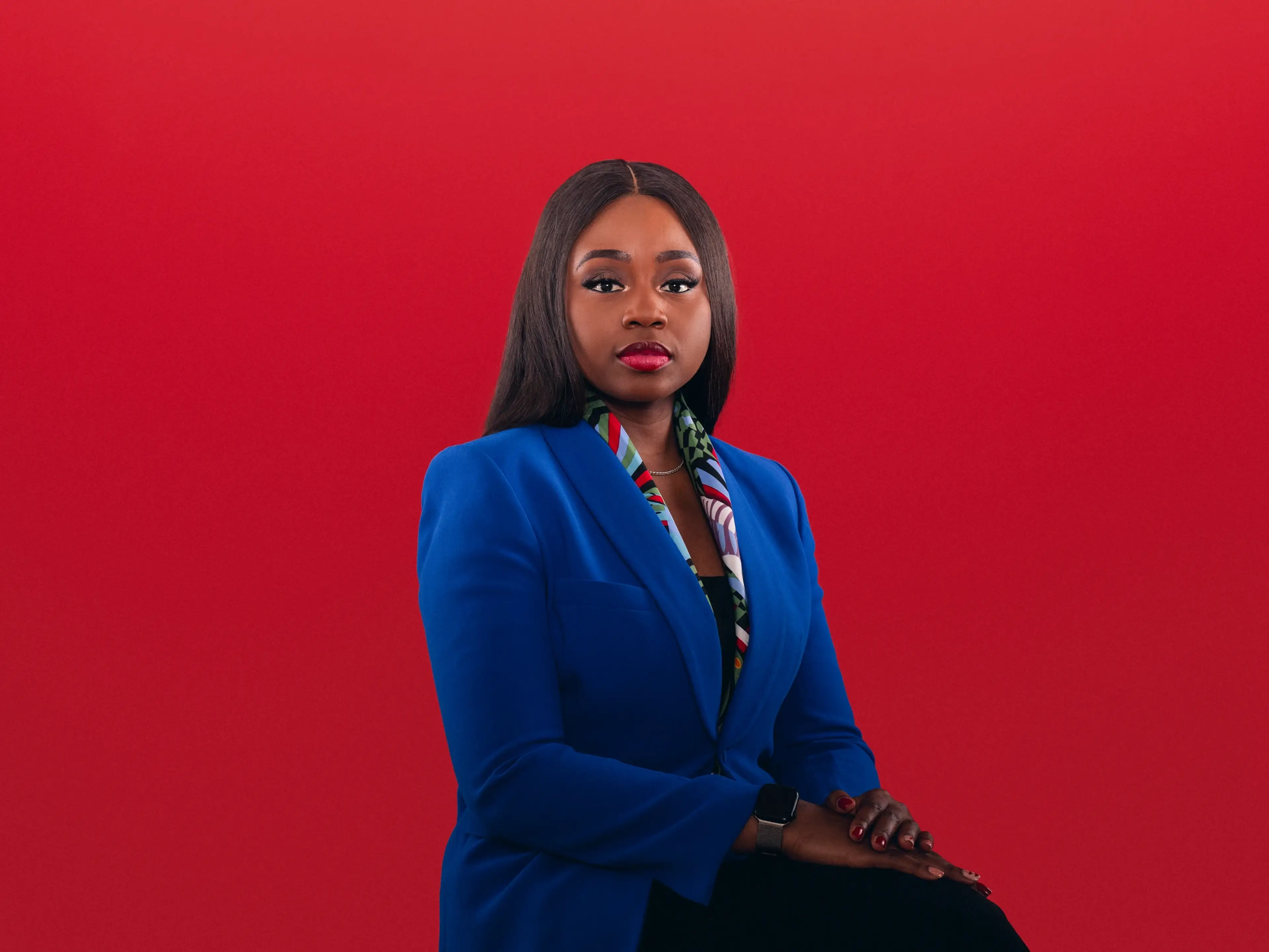 woman-blue-blazer-red-backdrop-portrait