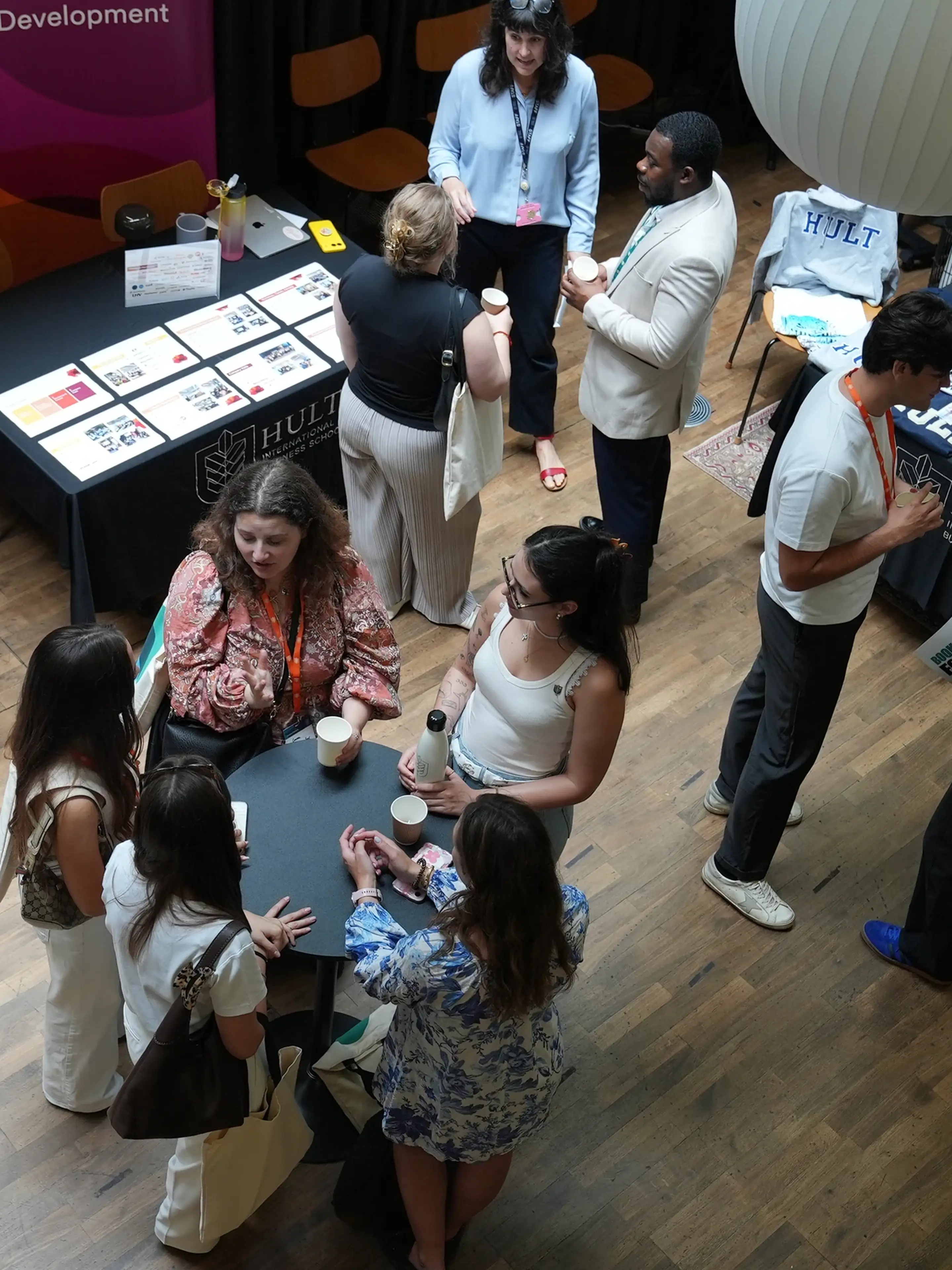 overhead shot of group around an exhibition table