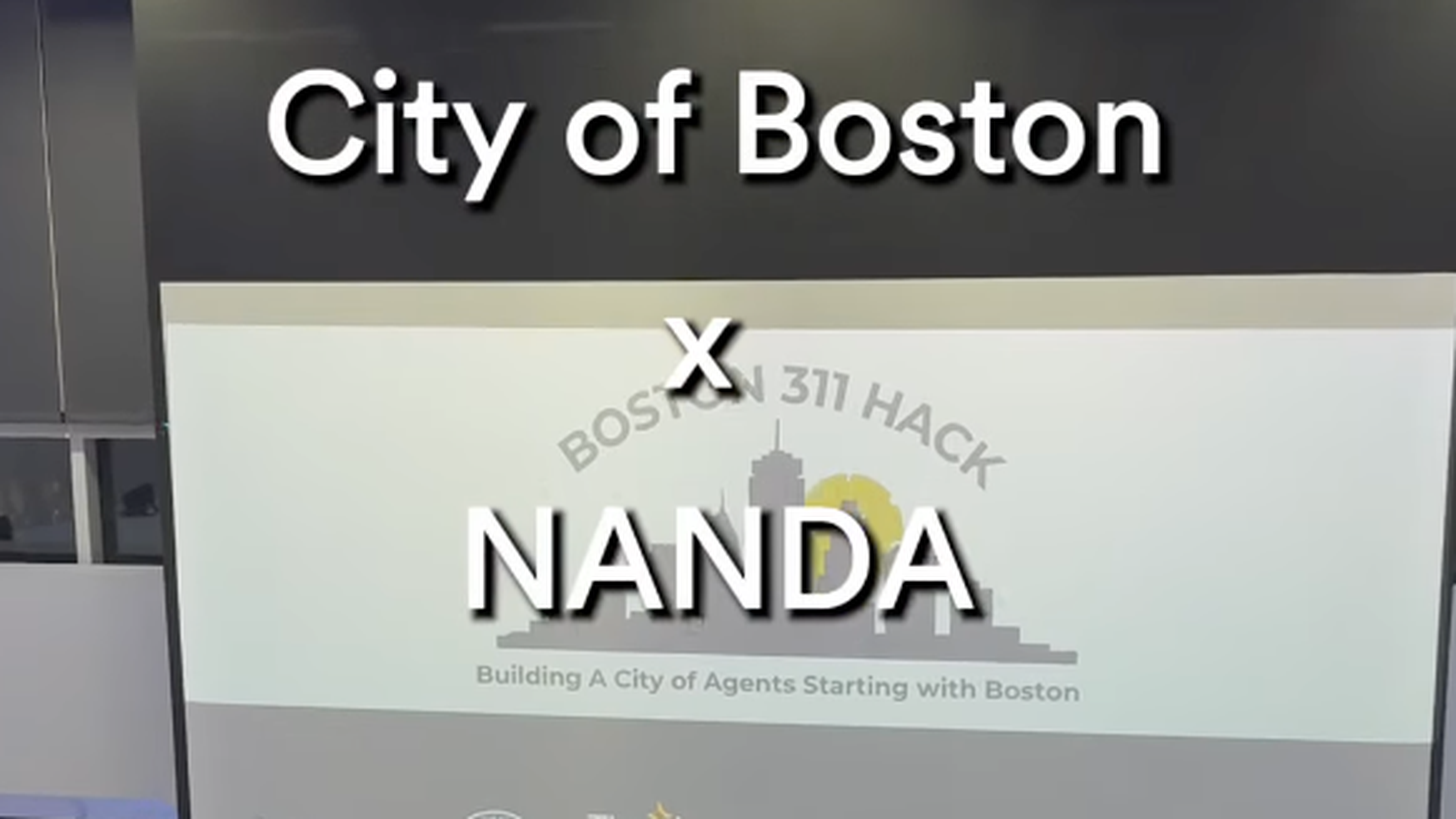 A person speaks on stage during the Boston 311 Hack event.
