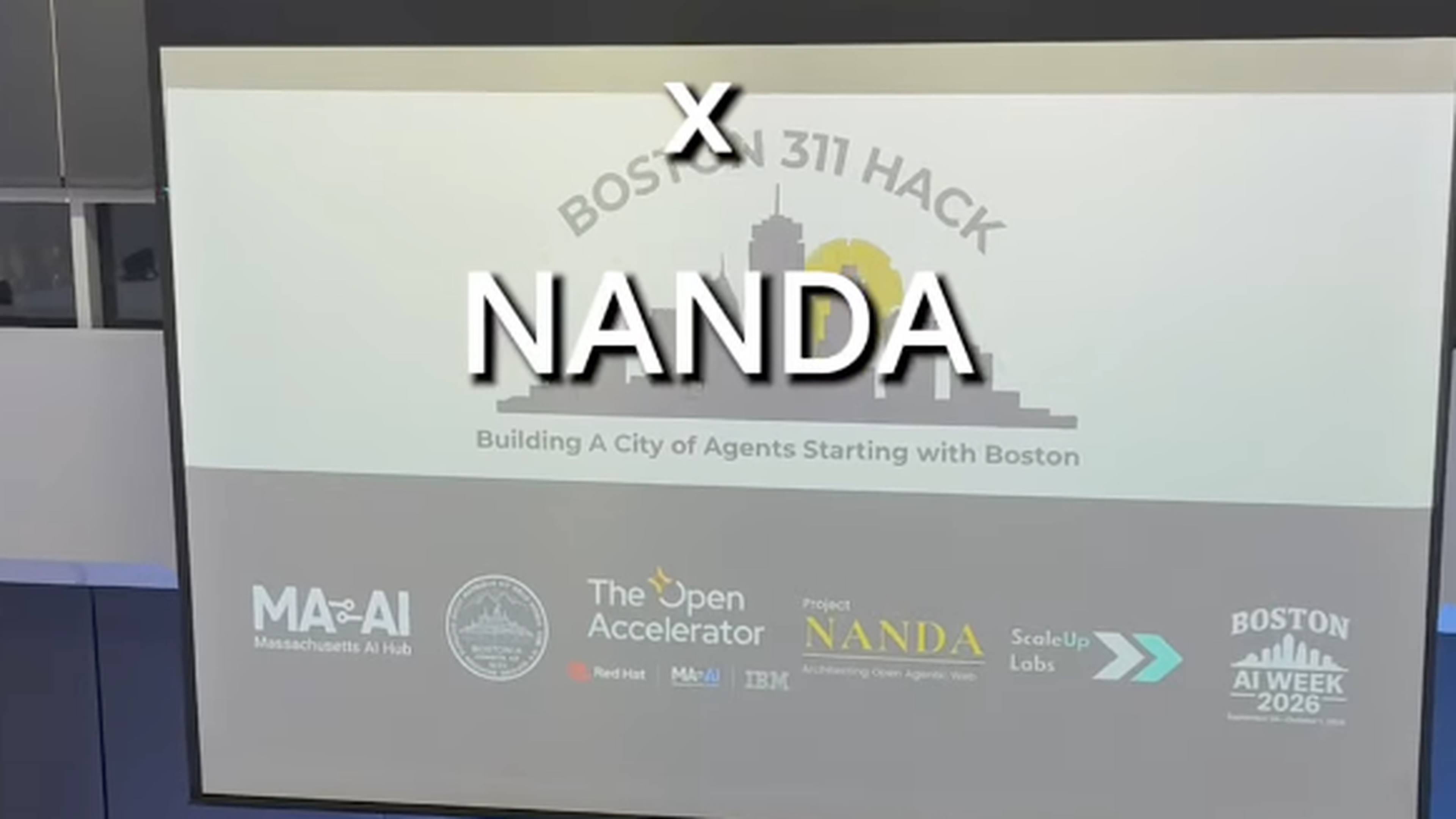 A person speaks on stage during the Boston 311 Hack event.