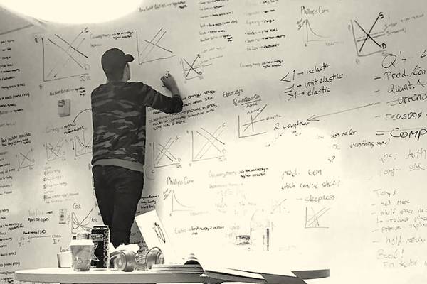 Hult student writing on whiteboard
