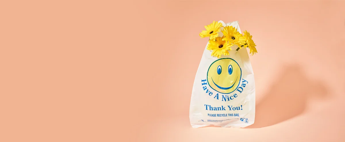 smiley plastic zak gele bloemen