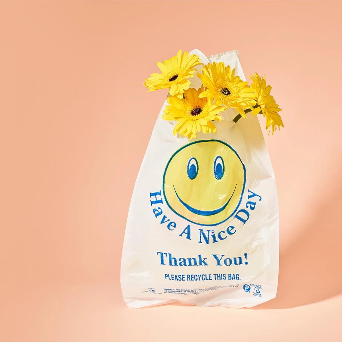 smiley plastic zak gele bloemen