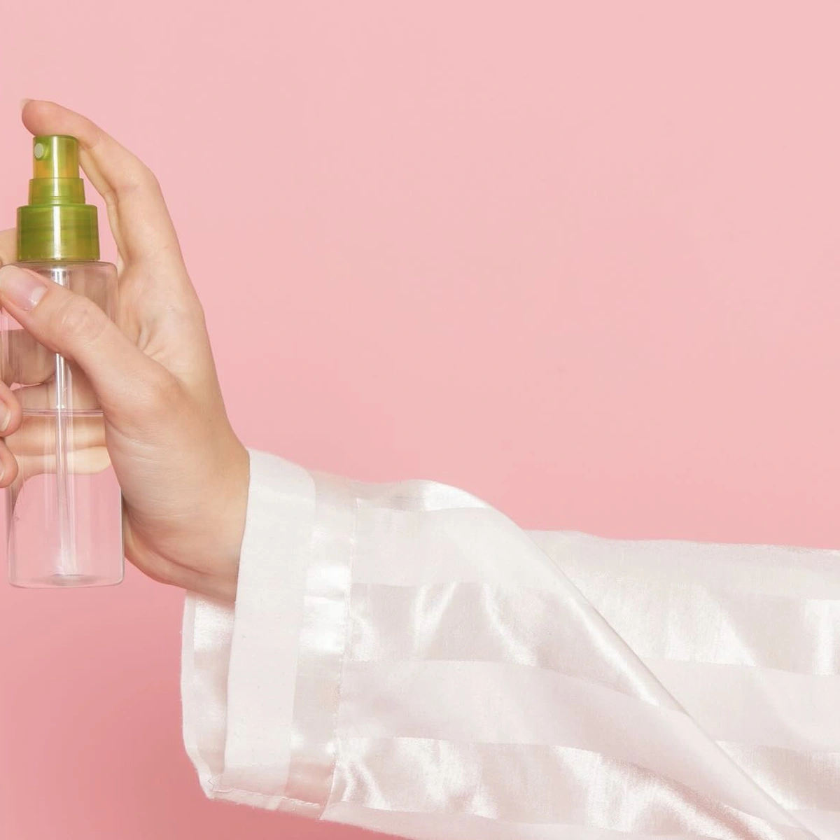 young-female-pajamas-sleep-mask-holding-make-up-spray-pink