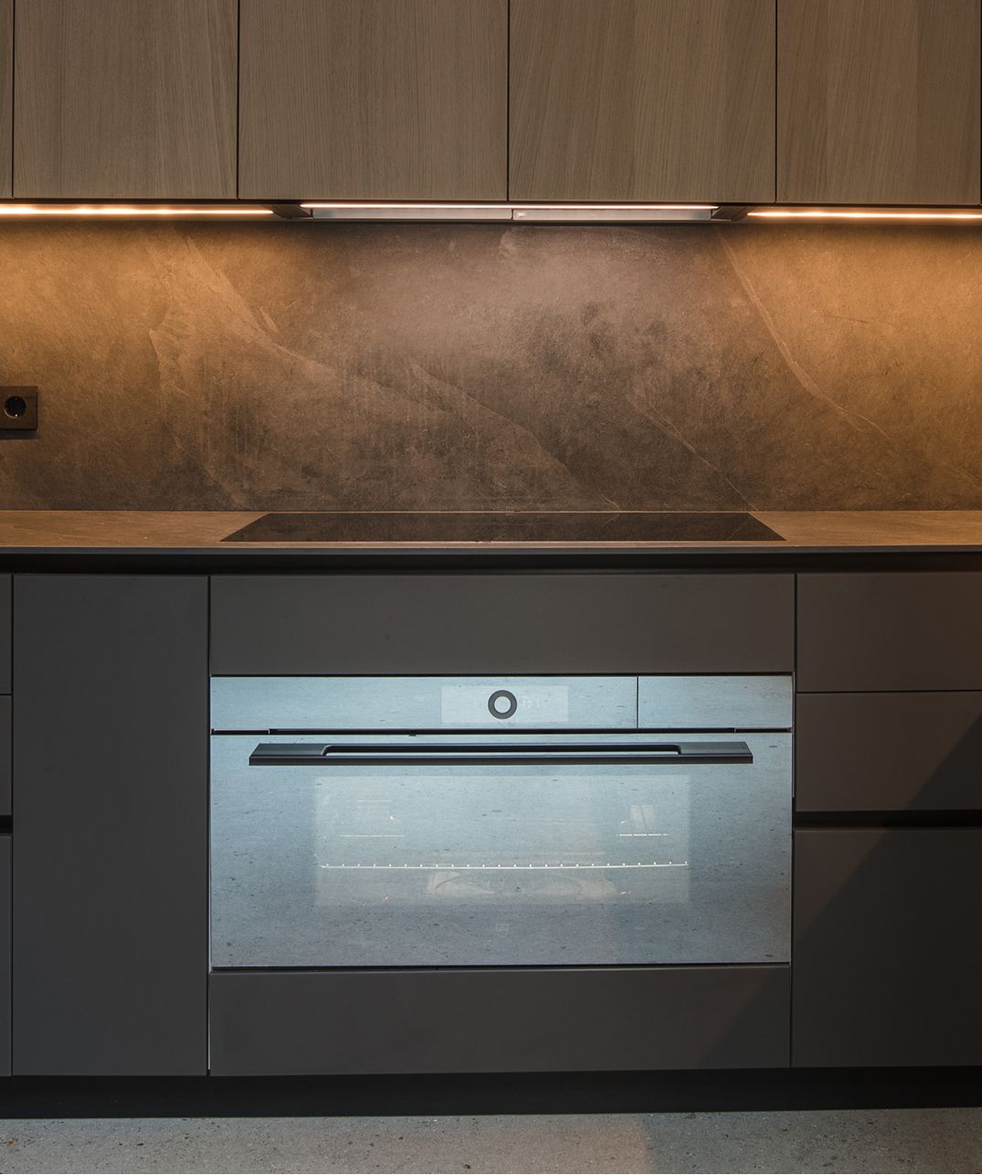 Dark-finish Desert Oak kitchen under a skylight, Cornet Chehwan