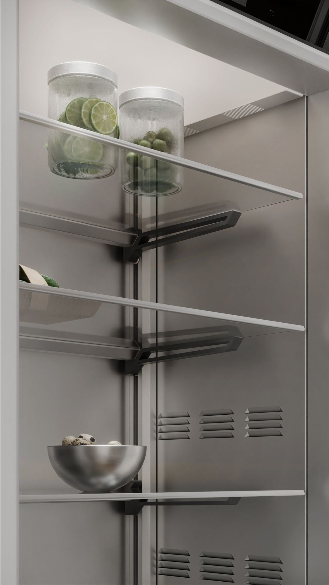 Interior of a modern refrigerator with stainless steel cladding and glass shelves, filled with food in containers.
