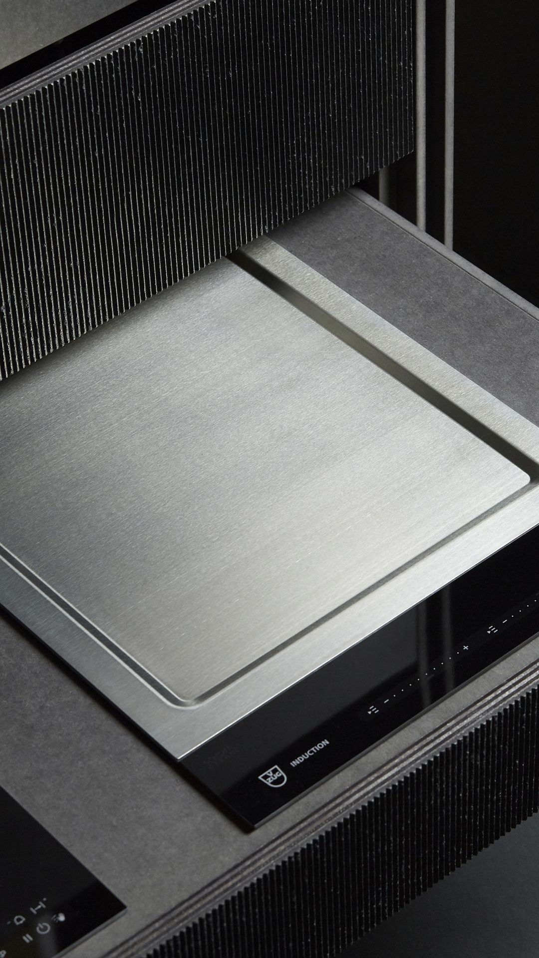 Stainless steel induction hob in a modern kitchen