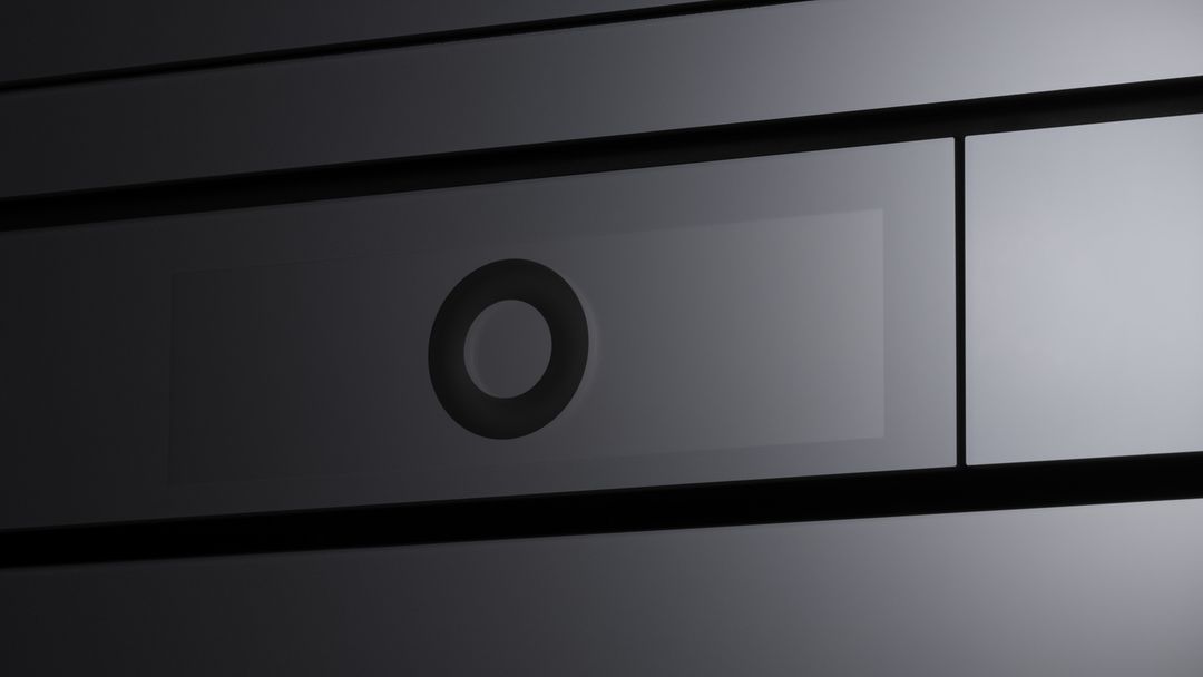 Close-up of a minimalist oven with a black design and clean lines.
