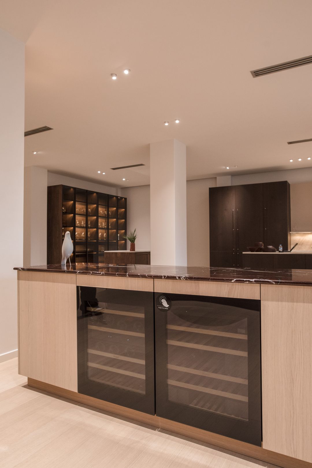 ASKO wine coolers integrated into a burgundy bar unit, Kitchen Avenue showroom