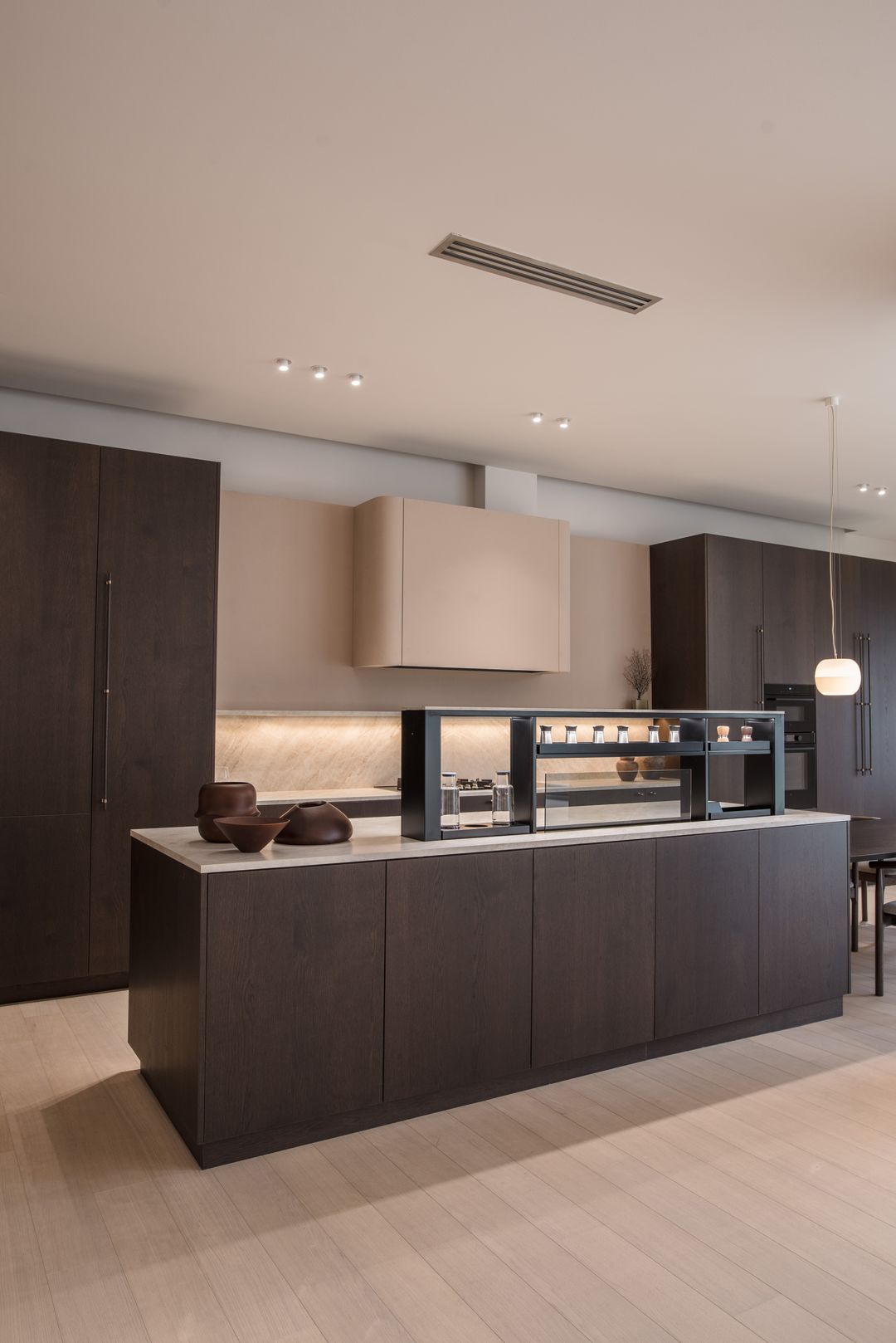FIM downdraft hood rising from the countertop, burley oak showroom kitchen