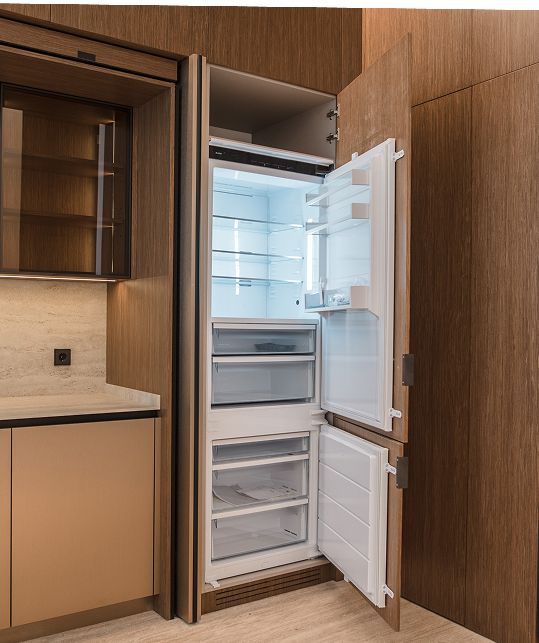 Integrated ASKO appliances in brown oak cabinetry, Saifi