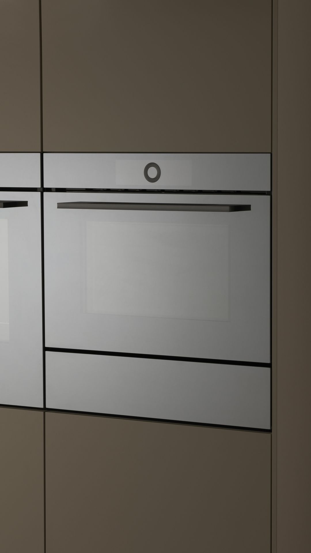 Minimalist mirror glass CombiMiwell V4000 microwave built into a kitchen