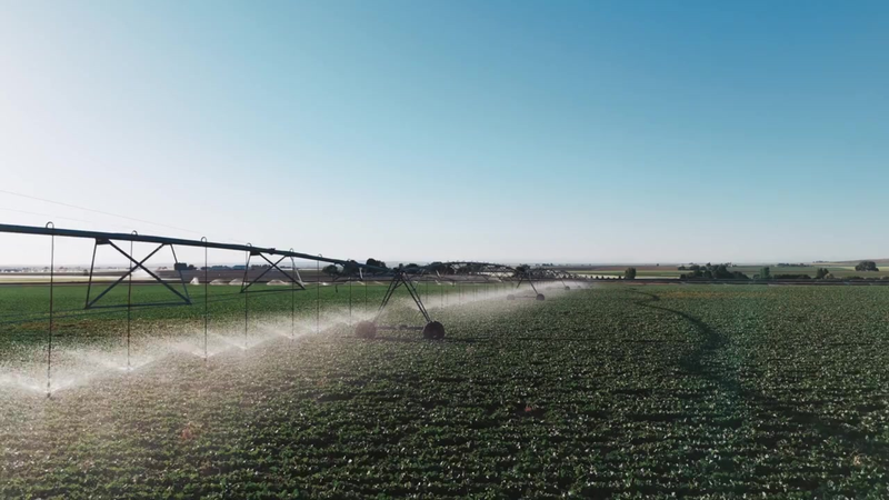 Engineer and grower reviewing irrigation components in the field