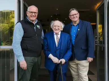 CEO Tim O'Mahony, President Higgins and Galway Branch Chair Kevin Quinn smiling, standing in a doorway