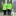 Two people in bright green jackets stand outside a building, one holding a cane, with a guide dog seated beside them.