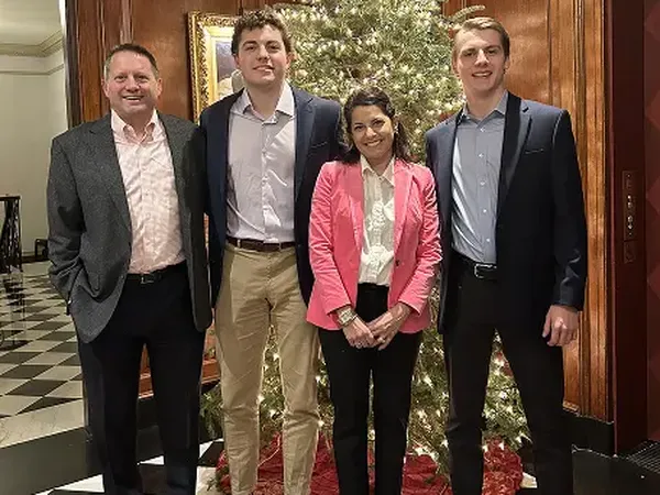 Craig Sumerel with family in front of a Christmas tree