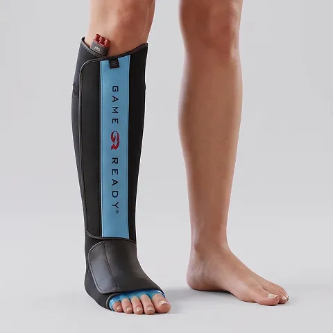 A woman is wearing a Game Ready wrap on her shin.