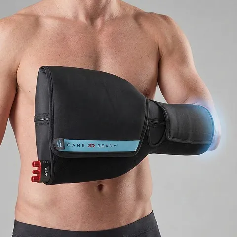 Man wearing a black, insulated arm wrap with adjustable straps, labeled "GAME READY".