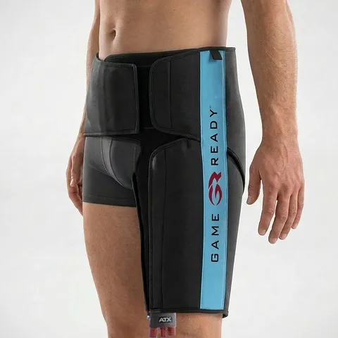 A person wearing a "Game Ready" hip compression wrap, designed for injury recovery.