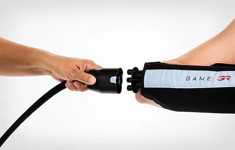 Game Ready hose connecting to a wrap worn on an arm, showing the hose connector attaching to the device's coupling.