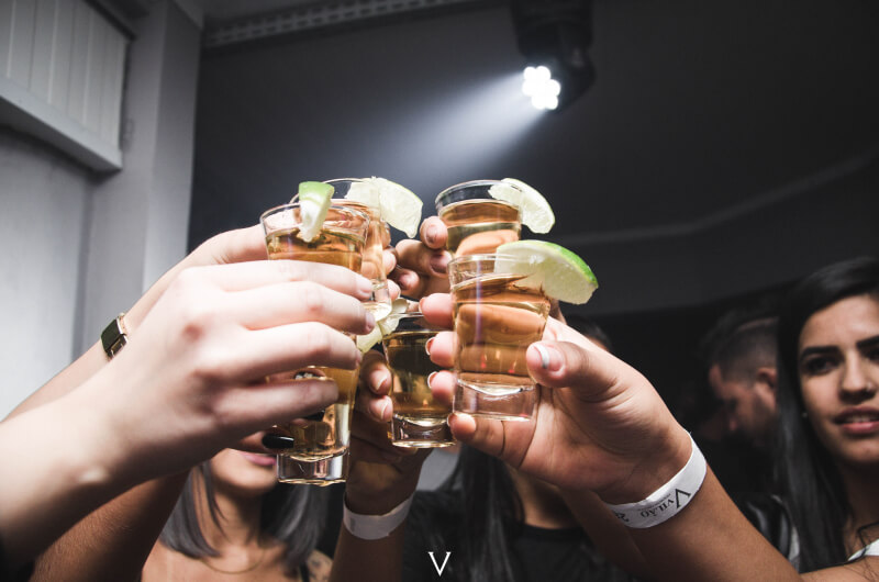 Music for pubs play as friends toast with shots