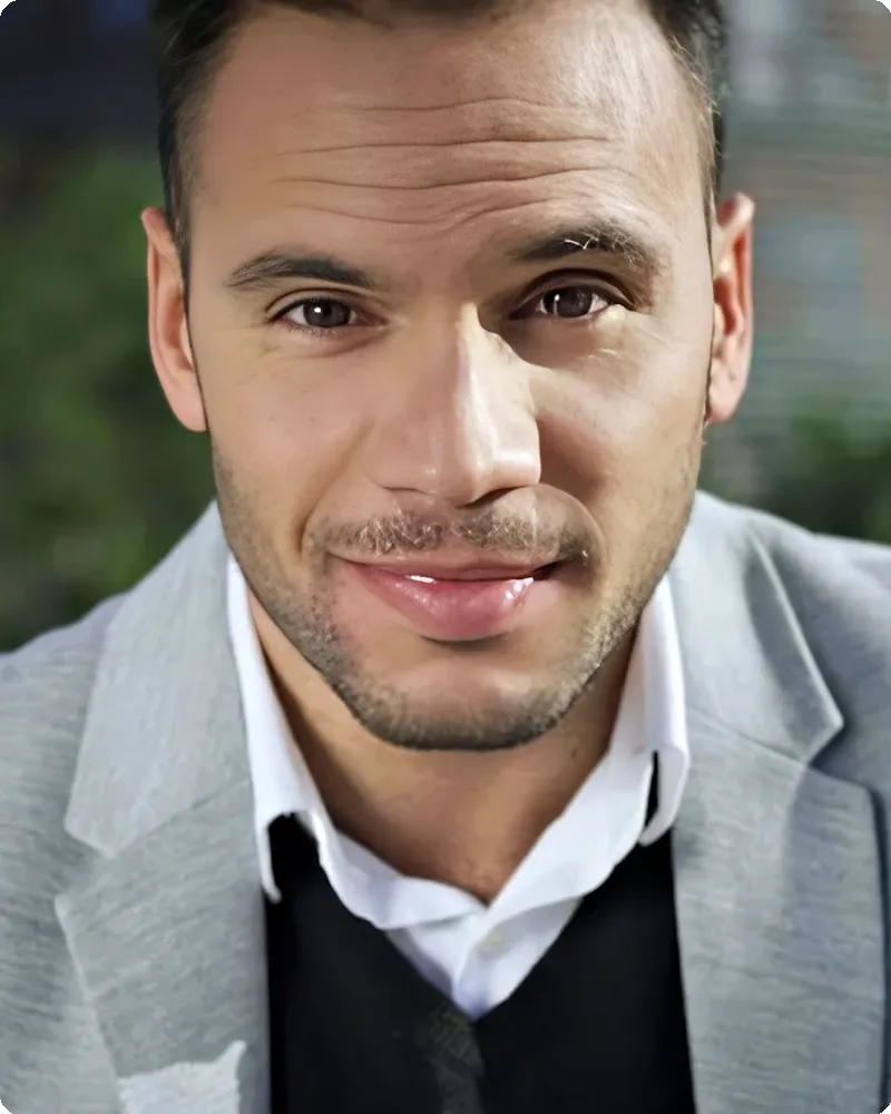 Confident professional in modern studio-polished portrait with warm natural-feel light, representing the Studio Polished mode