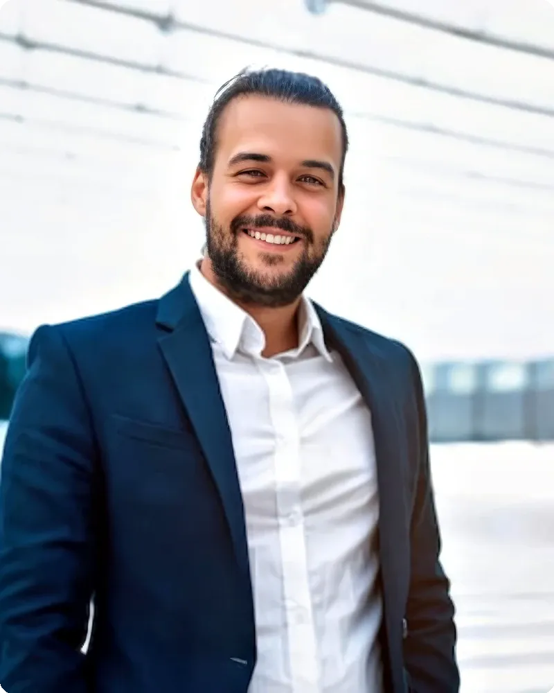 Wealth advisor in classic navy suit with warm expression, representing client-facing advisory attire