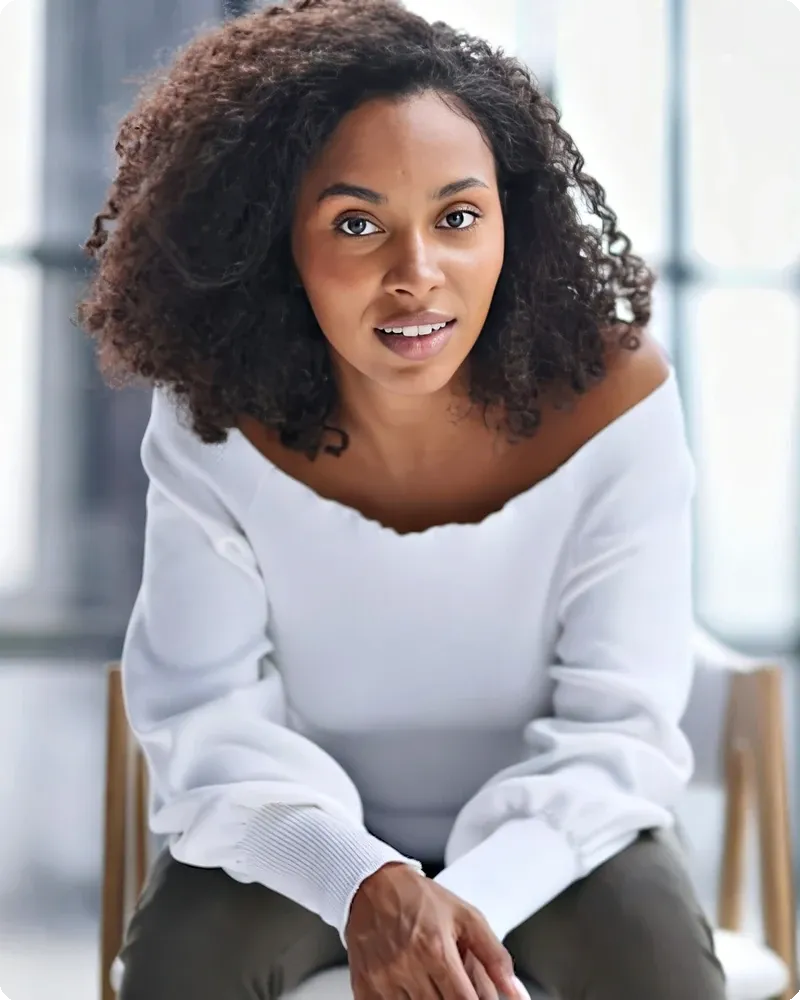 Professional in fine-gauge sweater with mid-tone backdrop and natural-feel light, representing the Smart Casual mode