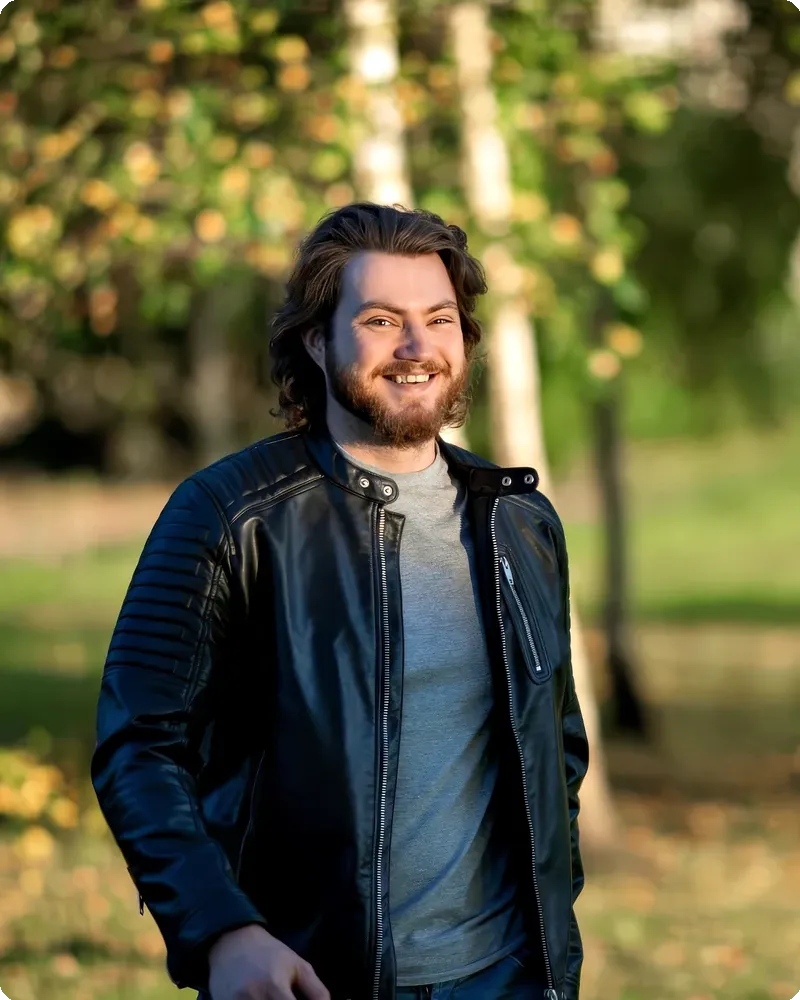 Professional with autumn-color trees backdrop in warm natural light, representing the Greenery & Park mode
