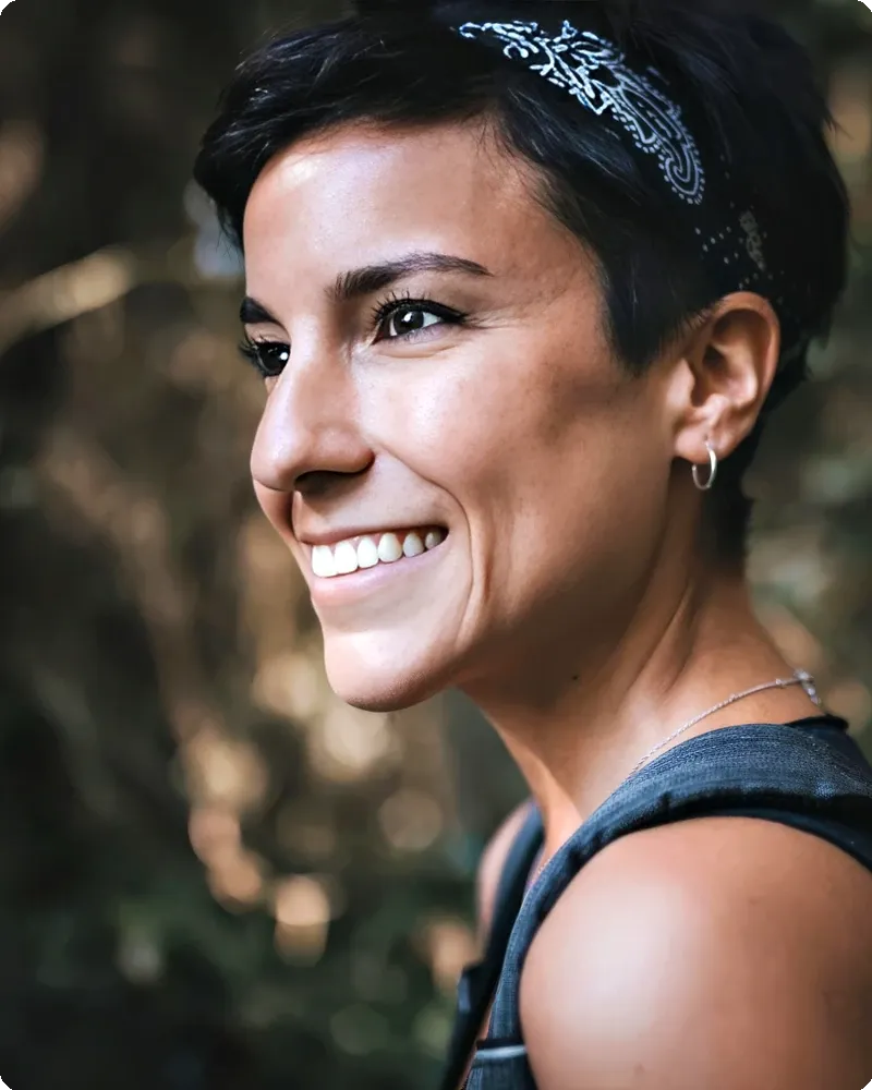 Smiling professional in soft outdoor light with naturally blurred backdrop, representing the Open Shade Natural mode